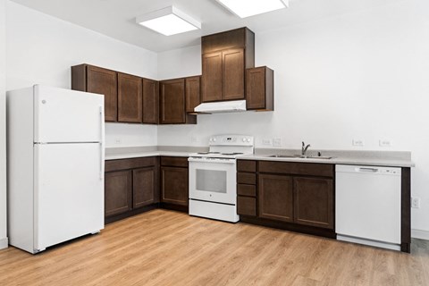 a kitchen with dark wood cabinets and white appliances